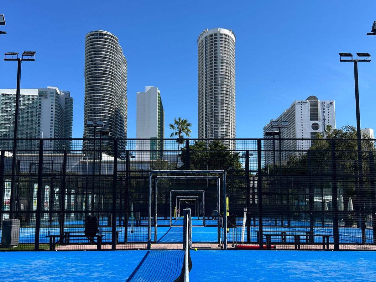 The padel courts at Real Padel Miami with the Edgewater towers behind