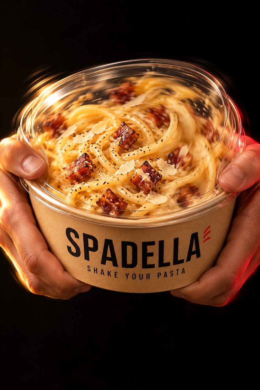 Two hands shaking a closed SPADELLA pasta bowl